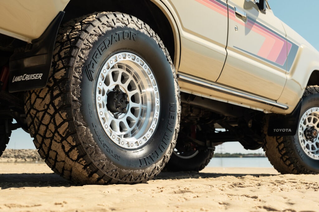 Close up of a Predator New Mutant X-AT tyre on a Toyota LandCruiser wheel parked on soft beach sand.